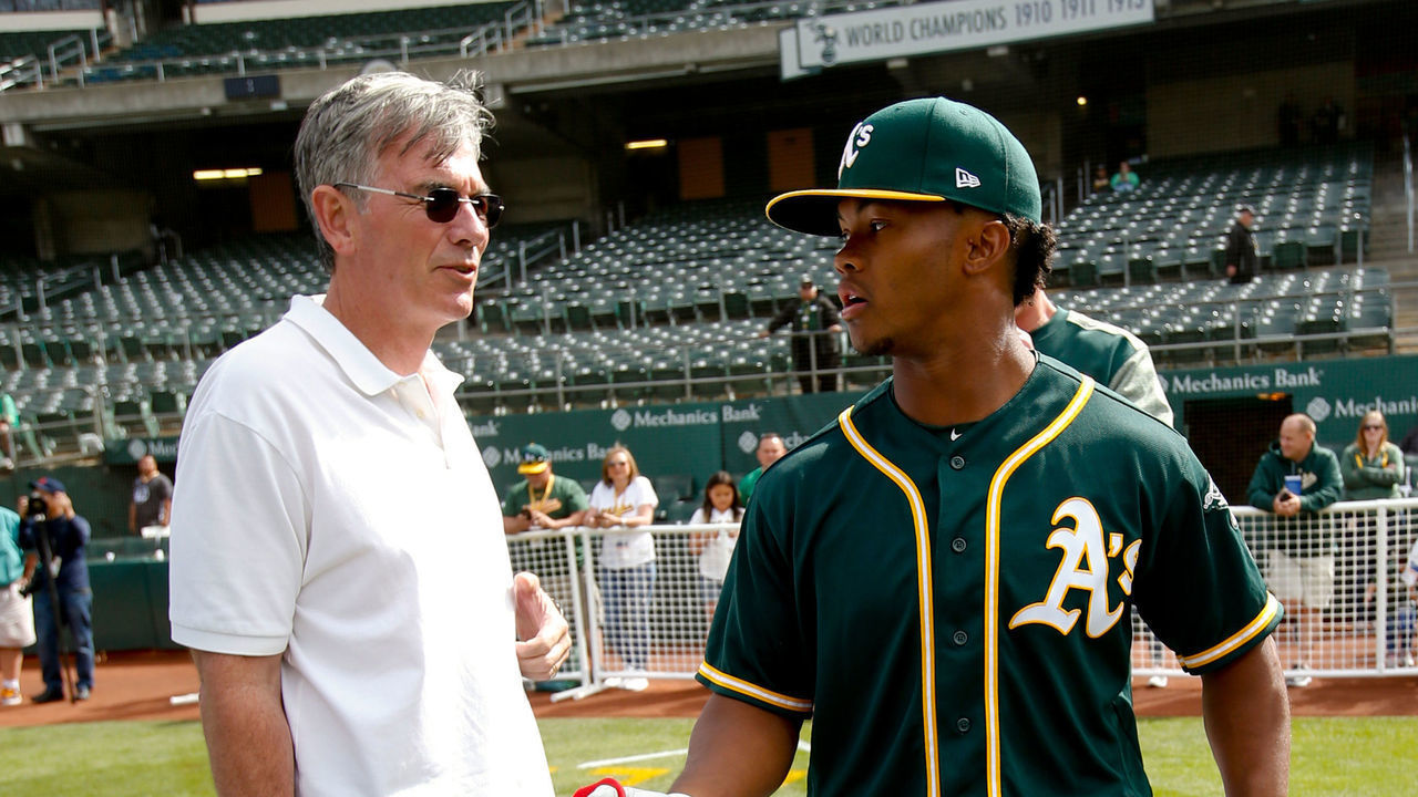 OAKLAND, CA - JUNE 15: Executive Vice President of Baseball Operations Billy Beane of the Oakland Athletics talks with first round draft pick Kyler Murray on the field after Murray signed his contract with the Oakland Athletics at the Oakland Alameda Coliseum on June 15, 2018 in Oakland, California.