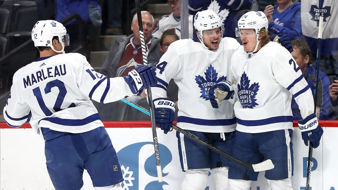 DENVER, COLORADO - FEBRUARY 12: Kasperi Kapanen #24 of the Toronto Maple Leafs is congratulated by Patrick Marleau #12 and Auston Matthews #34 after scoring a goal against the Colorado Avalanche in first period at the Pepsi Center on February 12, 2019 in Denver, Colorado.