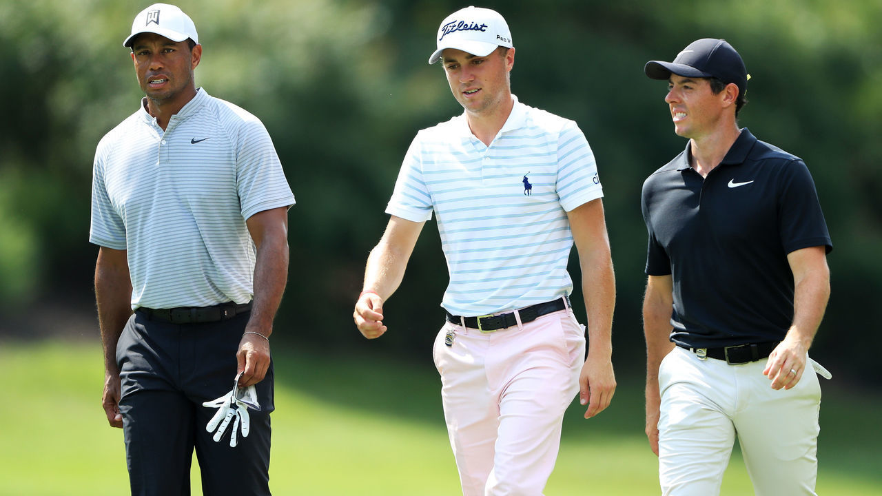 ST LOUIS, MO - AUGUST 10: (L-R) Tiger Woods of the United States, Justin Thomas of the United States and Rory McIlroy of Northern Ireland walk on the eighth hole during the second round of the 2018 PGA Championship at Bellerive Country Club on August 10, 2018 in St Louis, Missouri.