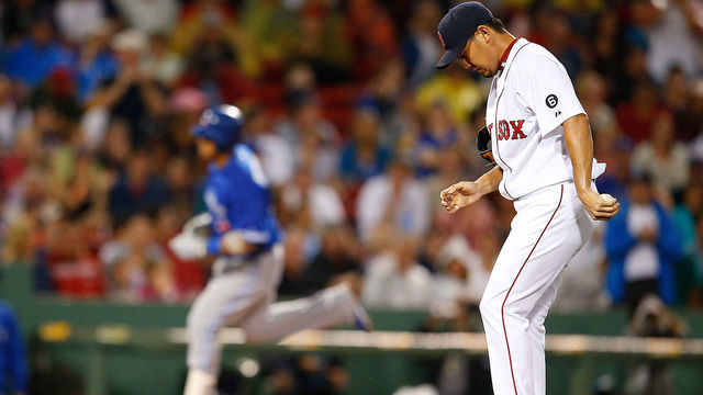 BOSTON, MA - SEPTEMBER 8: Daisuke Matsuzaka #18 of the Boston Red Sox reacts after giving up a home run to Yunel Escobar #5 of the Toronto Blue Jays in the fifth inning at Fenway Park on September 8, 2012 in Boston, Massachusetts.