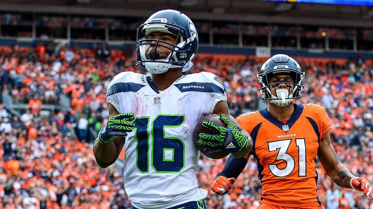 DENVER, CO - SEPTEMBER 9: Wide receiver Tyler Lockett #16 of the Seattle Seahawks scores a fourth quarter touchdown under coverage by defensive back Justin Simmons #31 of the Denver Broncos at Broncos Stadium at Mile High on September 9, 2018 in Denver, Colorado.