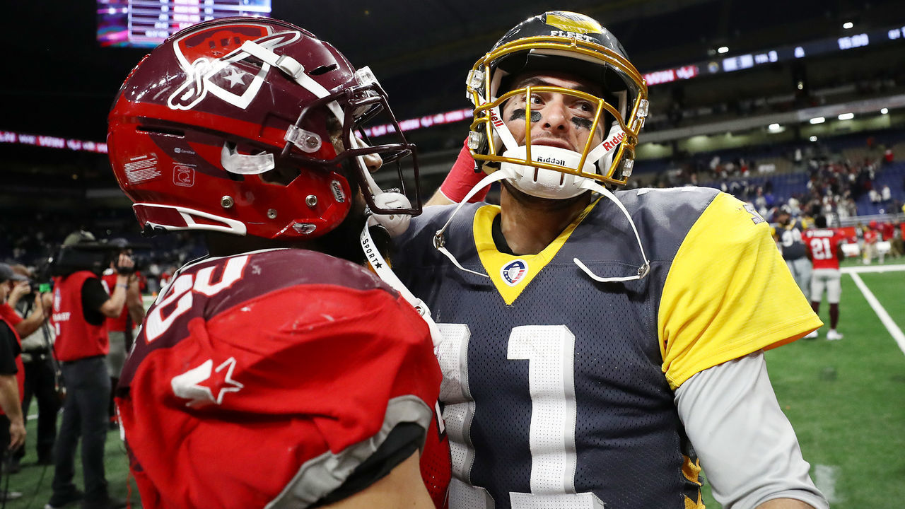 SAN ANTONIO, TEXAS - FEBRUARY 09: Kenneth Farrow II #20 of the San Antonio Commanders hugs Mike Bercovici #11 of the San Diego Fleet after the Commanders defeated the Fleet 15-6 in an Alliance of American Football game at the Alamodome on February 09, 2019 in San Antonio, Texas.