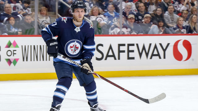 WINNIPEG, MB - DECEMBER 27: Nikolaj Ehlers #27 of the Winnipeg Jets keeps an eye on the play during second period action against the Calgary Flames at the Bell MTS Place on December 27, 2018 in Winnipeg, Manitoba, Canada. The Flames defeated the Jets 4-1.