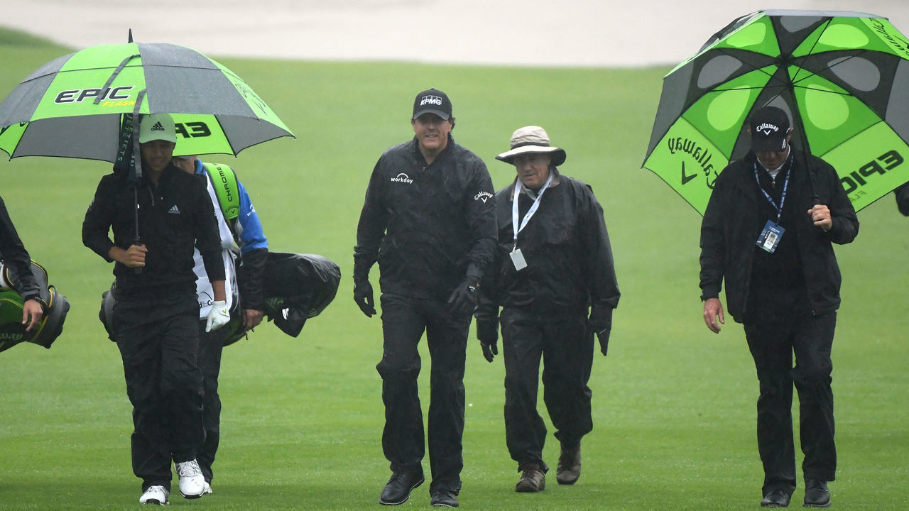 PACIFIC PALISADES, CALIFORNIA - FEBRUARY 14: Phil Mickelson walks off the 10th hole after a rain delay suspending play during the first round of the Genesis Open on February 14, 2019 in Pacific Palisades, California.