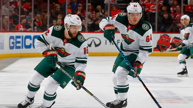NEWARK, NJ - FEBRUARY 22: Jason Zucker #16 and Mikael Granlund #64 of the Minnesota Wild in action against the New Jersey Devils on February 22, 2018 at Prudential Center in Newark, New Jersey.