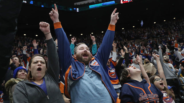 UNIONDALE, NEW YORK - DECEMBER 01: Fans celebrate a second period goal by Anders Lee #27 of the New York Islanders against the Columbus Blue Jackets at the Nassau Veterans Memorial Coliseum on December 01, 2018 in Uniondale, New York. The Islanders were playing in their first regular season game since April of 2015 when the team moved their home games to the Barclays Center in Brooklyn. The Islanders defeated the Blue Jackets 3-2.