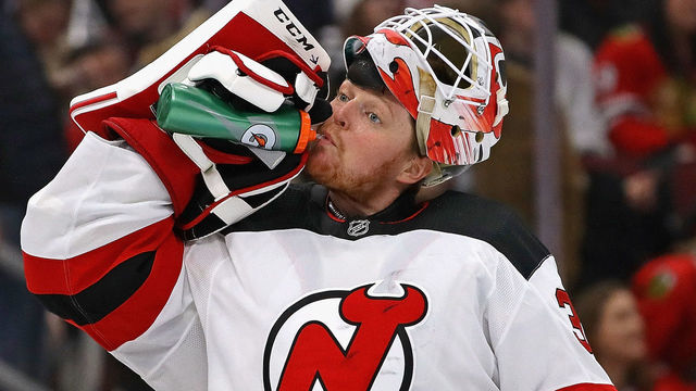 CHICAGO, ILLINOIS - FEBRUARY 14: Cory Schneider #35 of the New Jersey Devils takes a drink during a break against the Chicago Blackhawks at the United Center on February 14, 2019 in Chicago, Illinois. The Blackhawks defeated the devils 5-2.