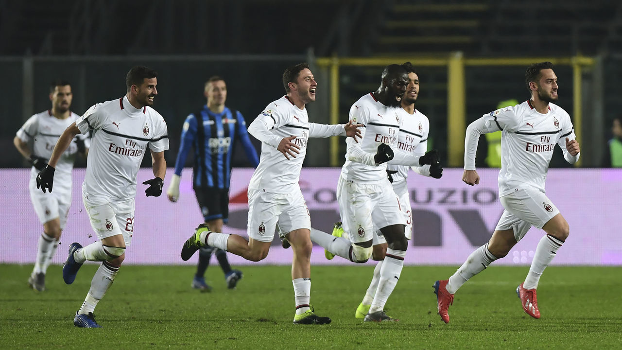 AC Milan's Turkish midfielder Hakan Calhanoglu (R) celebrates with teamnmates after scoring a goal during the Italian Serie A football match between Atalanta Bergamo and AC Milan on February 16, 2019, at the Atleti Azzurri d'Italia Stadium in Bergamo.