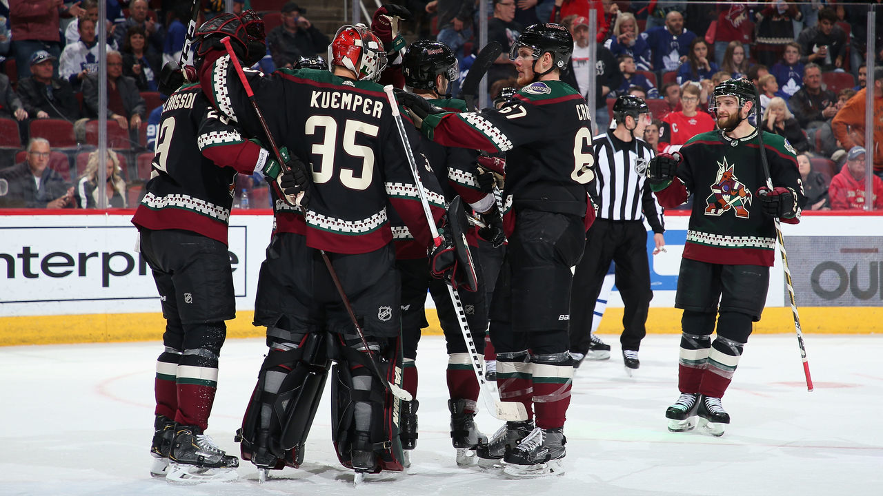 GLENDALE, ARIZONA - FEBRUARY 16: Goaltender Darcy Kuemper #35 of the Arizona Coyotes is congratulated by teammates Oliver Ekman-Larsson #23 Lawson Crouse #67 after defeating the Toronto Maple Leafs in the NHL game at Gila River Arena on February 16, 2019 in Glendale, Arizona. The Coyotes defeated the Maple Leafs 2-0.