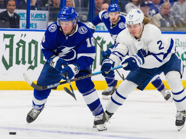 TAMPA, FL - JANUARY 17: J.T. Miller #10 of the Tampa Bay Lightning skates against Kasperi Kapanen #24 of the Toronto Maple Leafs during the third period at Amalie Arena on January 17, 2019 in Tampa, Florida.