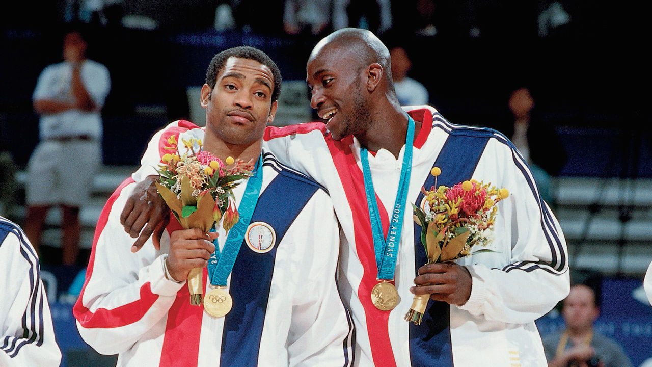 SYDNEY, AUSTRALIA - 2000: (L-R) Vince Carter and Kevin Garnett of the United States National Team proudly display their Gold Medals during the 2000 Summer Olympics Medal Ceremony in Sydney, Australia. NOTE TO USER: User expressly acknowledges that, by downloading and or using this photograph, User is consenting to the terms and conditions of the Getty Images License agreement. Mandatory Copyright Notice: Copyright 2000 NBAE