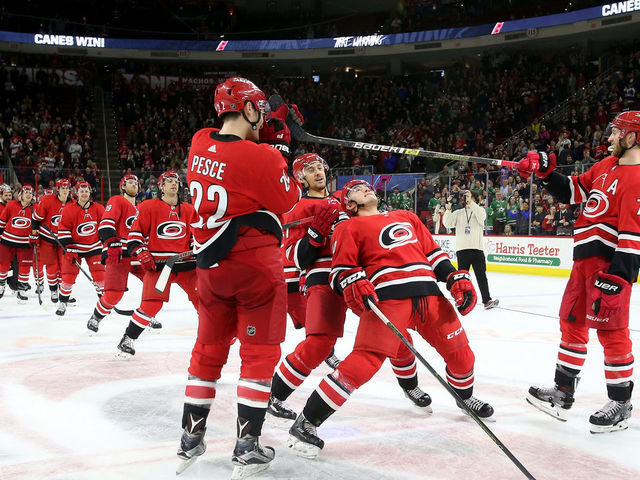 RALEIGH, NC - FEBRUARY 16: Members of the Carolina Hurricanes perform a limbo during the Storm Surge following a victory over the Dallas Stars during an NHL game on February 16, 2019 at PNC Arena in Raleigh, North Carolina.