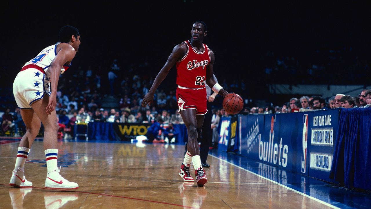 LANDOVER, MD - CIRCA 1985: Michael Jordan #23 of the Chicago Bulls dribbles the ball up court guarded by Jeff Malone #24 of the Washington Bullets during an NBA basketball game circa 1985 at the Capital Centre in Landover, Maryland. Jordan played for the Bulls from 1984-93 and 1995 - 98.
