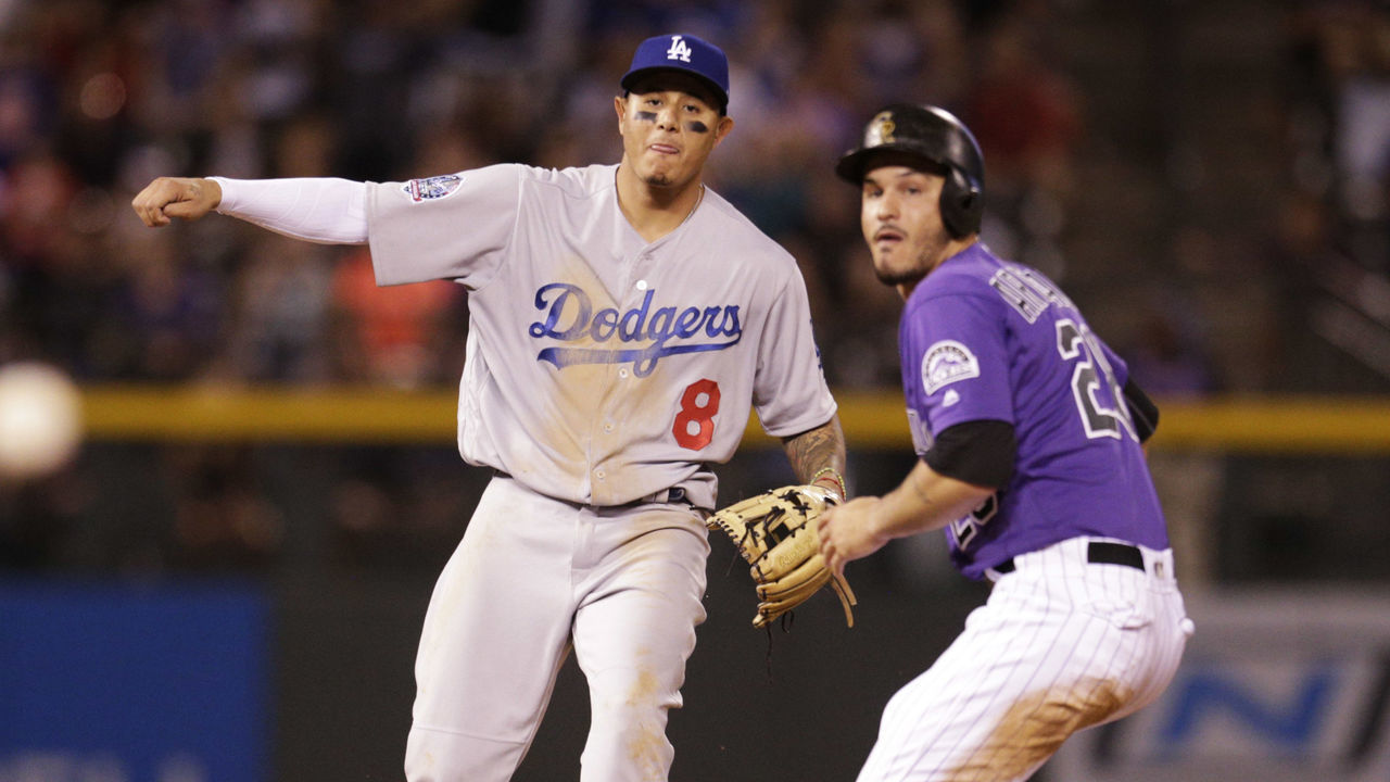 DENVER, CO - AUGUST 11: Manny Machado #8 of the Los Angeles Dodgers and Nolan Arenado #28 of the Colorado Rockies watch as Machado's throw to first base on an attempted double play falls low after Arenado was forced out at second base in the ninth inning at Coors Field on August 11, 2018 in Denver, Colorado. Colorado won 3-2.