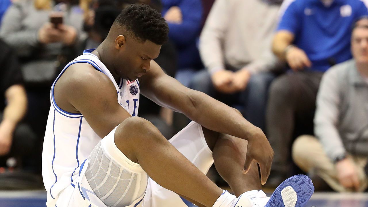 DURHAM, NORTH CAROLINA - FEBRUARY 20: Zion Williamson #1 of the Duke Blue Devils reacts after falling as his shoe breaks against Luke Maye #32 of the North Carolina Tar Heels during their game at Cameron Indoor Stadium on February 20, 2019 in Durham, North Carolina.