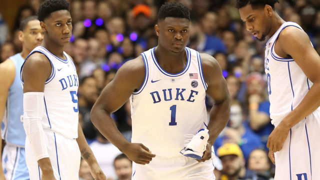 DURHAM, NORTH CAROLINA - FEBRUARY 20: Teammates RJ Barrett #5 and Marques Bolden #20 of the Duke Blue Devils watch as Zion Williamson #1 of the Duke Blue Devils reacts after falling as his shoe breaks against Luke Maye #32 of the North Carolina Tar Heels during their game at Cameron Indoor Stadium on February 20, 2019 in Durham, North Carolina.