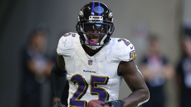ATLANTA, GA - DECEMBER 02: Baltimore Ravens cornerback Tavon Young (25) celebrates after scoring a touchdown off a fumble in an NFL football game between the Baltimore Ravens and Atlanta Falcons on December 2, 2018 at Mercedes-Benz Stadium.