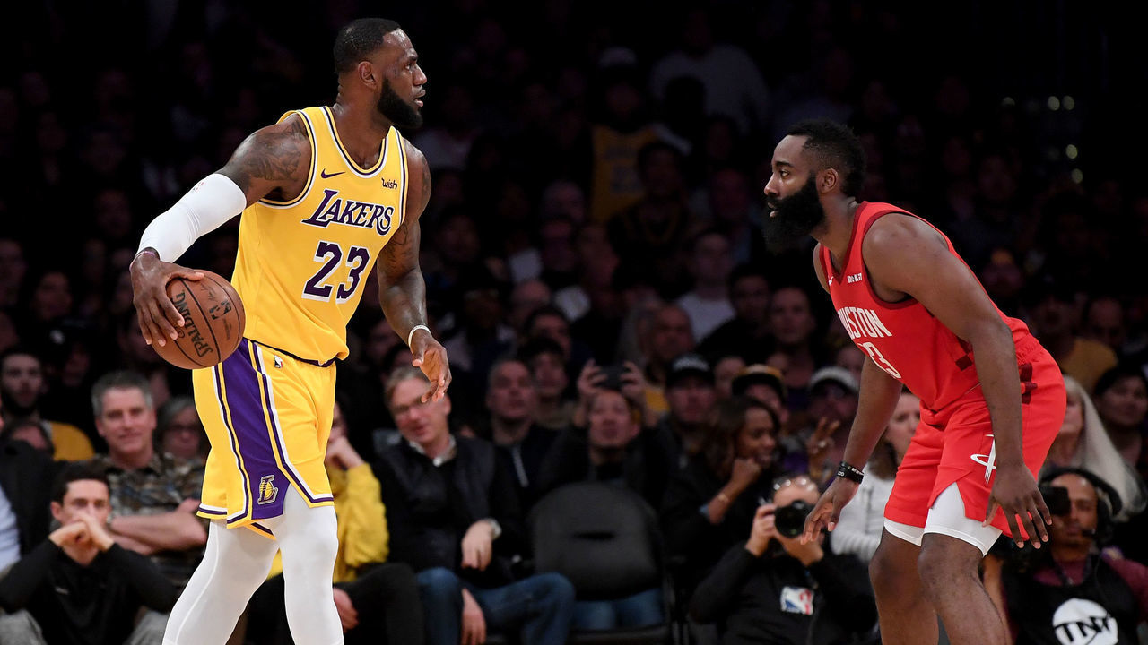 LOS ANGELES, CALIFORNIA - FEBRUARY 21: LeBron James #23 of the Los Angeles Lakers dribbles toward James Harden #13 of the Houston Rockets during the first half at Staples Center on February 21, 2019 in Los Angeles, California.