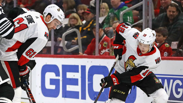 CHICAGO, ILLINOIS - FEBRUARY 18: Mark Stone #61 and Ryan Dzingel #18 of the Ottawa Senators battle for the puck with Carl Dahlstrom #63 of the Chicago Blackhawks at the United Center on February 18, 2019 in Chicago, Illinois.