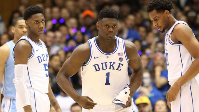 DURHAM, NORTH CAROLINA - FEBRUARY 20: Teammates RJ Barrett #5 and Marques Bolden #20 of the Duke Blue Devils watch as Zion Williamson #1 of the Duke Blue Devils reacts after falling as his shoe breaks against Luke Maye #32 of the North Carolina Tar Heels during their game at Cameron Indoor Stadium on February 20, 2019 in Durham, North Carolina.