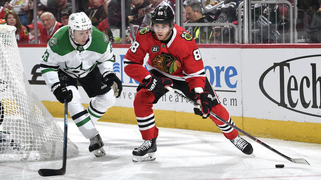 CHICAGO, IL - FEBRUARY 24: Patrick Kane #88 of the Chicago Blackhawks approaches the puck ahead of Esa Lindell #23 of the Dallas Stars in the first period at the United Center on February 24, 2019 in Chicago, Illinois.