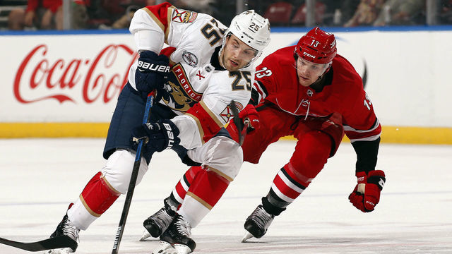SUNRISE, FL - FEBRUARY 21: Derick Brassard #25 of the Florida Panthers skates with the puck against Warren Foegele #13 of the Carolina Hurricanes at the BB&T Center on February 21, 2019 in Sunrise, Florida.