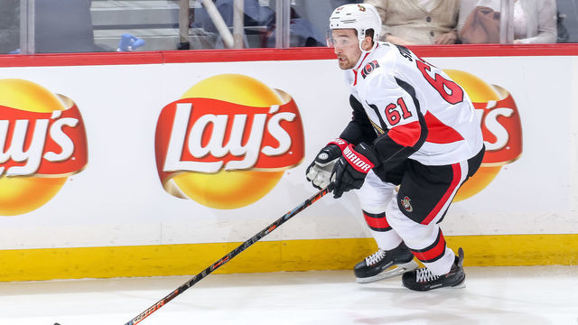 WINNIPEG, MB - FEBRUARY 16: Mark Stone #61 of the Ottawa Senators plays the puck up the ice during second period action against the Winnipeg Jets at the Bell MTS Place on February 16, 2019 in Winnipeg, Manitoba, Canada. The Sens defeated the Jets 4-3 in overtime.