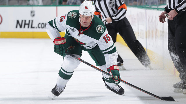 DALLAS, TX - FEBRUARY 1: Matt Hendricks #15 of the Minnesota Wild handles the puck against the Dallas Stars at the American Airlines Center on February 1, 2019 in Dallas, Texas.
