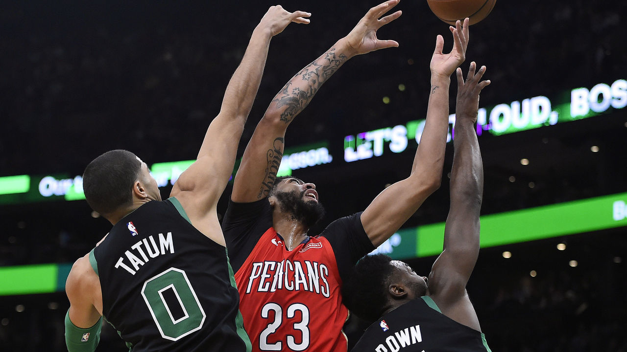 BOSTON, MA - DECEMBER 10: Jayson Tatum #0 of the Boston Celtics, left, and teammate Jaylen Brown defend against Anthony Davis #23 of the New Orleans Pelicans during the first half of an NBA basketball game at TD Garden in Boston, Massachusetts on December 10, 2018.