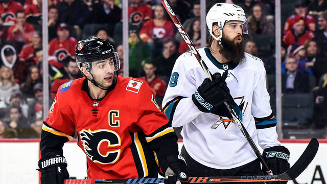 CALGARY, AB - FEBRUARY 07: Calgary Flames Defenceman Mark Giordano (5) and San Jose Sharks Defenceman Brent Burns (88) watch the play during the third period of an NHL game where the Calgary Flames hosted the San Jose Sharks on February 7, 2019, at the Scotiabank Saddledome in Calgary, AB.