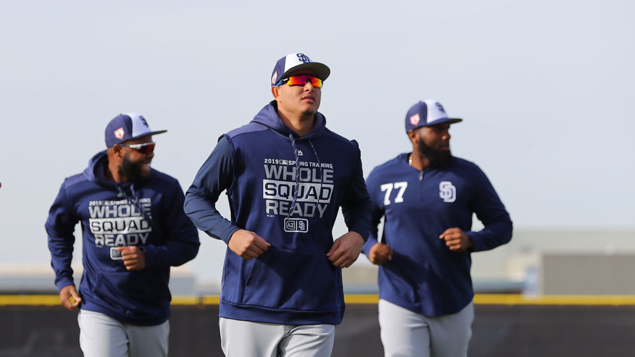 PEORIA, AZ - FEBRUARY 25: Manny Machado #13 and Eric Hosmer #30 of the San Diego Padres warm up during a workout on Monday, February 25, 2019 at Peoria Sports Complex in Peoria, Arizona.