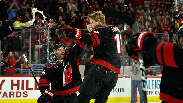 RALEIGH, NC - FEBRUARY 15: Warren Foegele #13 of the Carolina Hurricanes celebrates during the team Storm Surge following a victory over the Edmonton Oilers during an NHL game on February 15, 2019 at PSNC Arena in Raleigh, North Carolina.