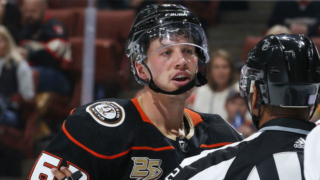 ANAHEIM, CA - NOVEMBER 4: Rickard Rakell #67 of the Anaheim Ducks exchanges words with a Columbus Blue Jackets player as he is restrained by linesman Shandor Alphonso #52 during the third period of the game at Honda Center on November 4, 2018 in Anaheim, California.