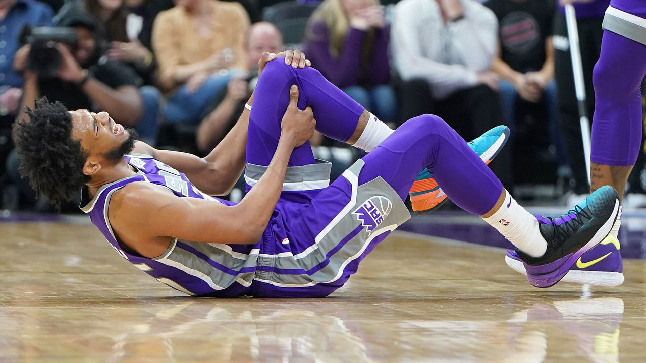 SACRAMENTO, CA - FEBRUARY 27: Marvin Bagley III #35 of the Sacramento Kings falls to the floor holding his left knee after getting hurt against the Milwaukee Bucks during the second half of an NBA basketball game at Golden 1 Center on February 27, 2019 in Sacramento, California.