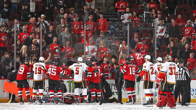 NEWARK, NEW JERSEY - FEBRUARY 27: Mirco Mueller #25 of the New Jersey Devils is injured during the third period injury against the Calgary Flames at the Prudential Center on February 27, 2019 in Newark, New Jersey. The Flames defeated the devils 2-1.