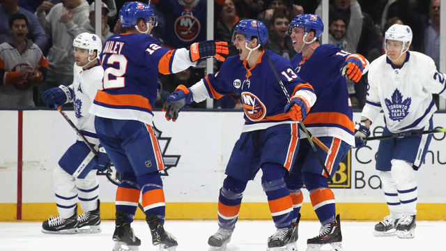 UNIONDALE, NEW YORK - FEBRUARY 28: Anthony Beauvillier #18 of the New York Islanders scores at 16:16 of the first period against the Toronto Maple Leafs and is joined by Josh Bailey #12 (l) and Mathew Barzal #13 (c) at NYCB Live's Nassau Coliseum on February 28, 2019 in Uniondale City.