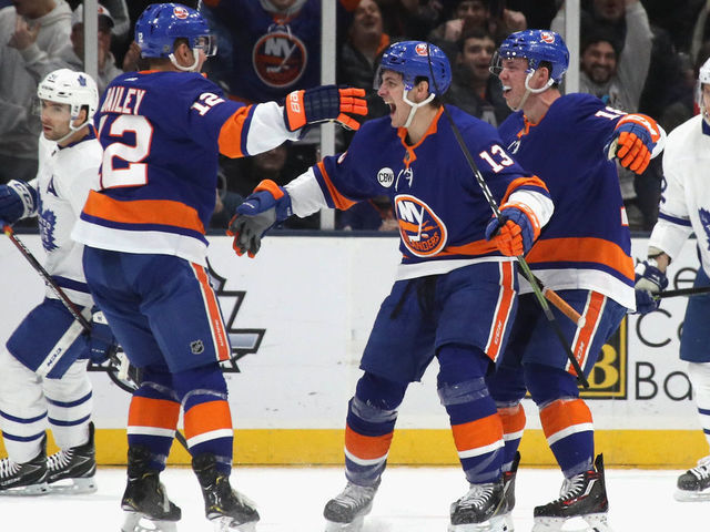 UNIONDALE, NEW YORK - FEBRUARY 28: Anthony Beauvillier #18 of the New York Islanders scores at 16:16 of the first period against the Toronto Maple Leafs and is joined by Josh Bailey #12 (l) and Mathew Barzal #13 (c) at NYCB Live's Nassau Coliseum on February 28, 2019 in Uniondale City.