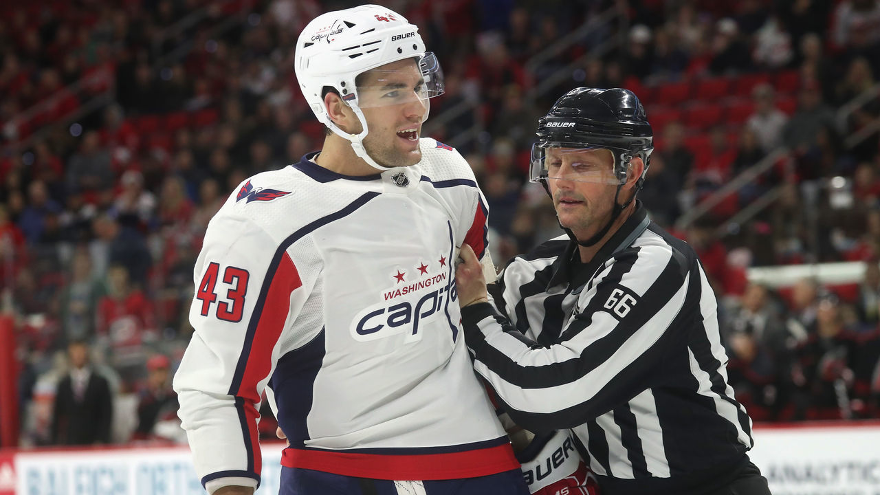 RALEIGH, NC - DECEMBER 14: Tom Wilson #43 of the Washington Capitals debates a call on the ice and is ushered to the penalty box by linesman Larry Gibbs #66 during an NHL game on December 14, 2018 at PNC Arena in Raleigh, North Carolina.