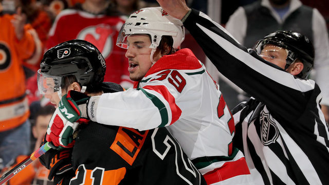 NEWARK, NEW JERSEY - MARCH 01: Kurtis Gabriel #39 of the New Jersey Devils and Scott Laughton #21 of the Philadelphia Flyers get in a shoving match in the third period on March 01, 2019 at Prudential Center in Newark, New Jersey.The Philadelphia Flyers defeated the New Jersey Devils 6-3.