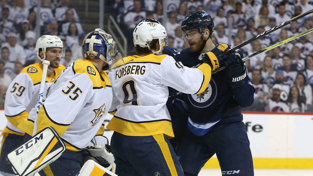 WINNIPEG, MANITOBA - MAY 1: Filip Forsberg #9 of the Nashville Predators fends off Adam Lowry #17 of the Winnipeg Jets in Game Three of the Western Conference Second Round during the 2018 NHL Stanley Cup Playoffs on May 1, 2018 at Bell MTS Place in Winnipeg, Manitoba, Canada. *** Local Caption *** Filip Forsberg; Adam Lowry