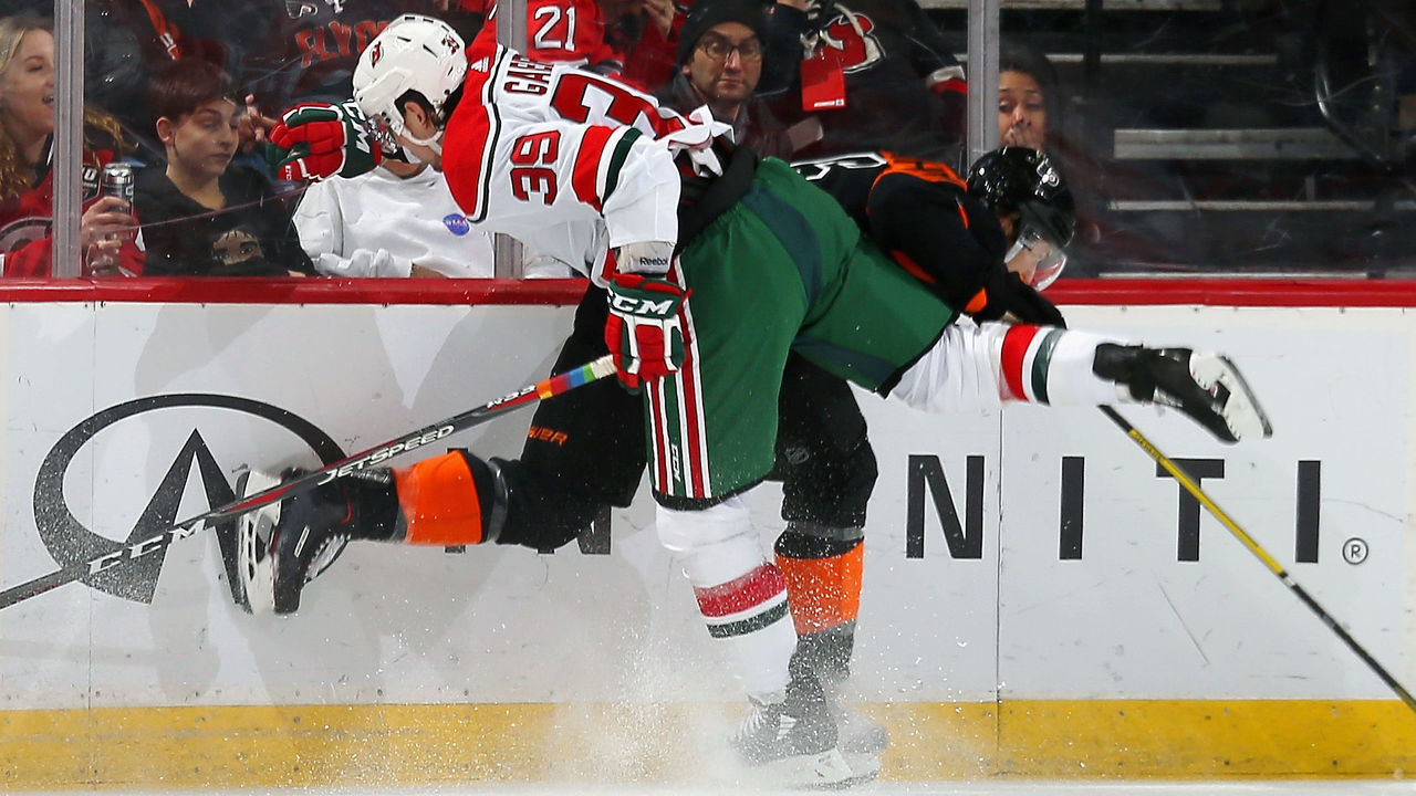 NEWARK, NJ - MARCH 01: Kurtis Gabriel #39 of the New Jersey Devils and Travis Sanheim #6 of the Philadelphia Flyers come together at the bords during the game at Prudential Center on March 1, 2019 in Newark, New Jersey.