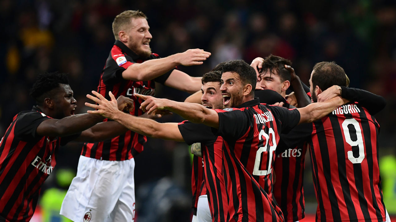 AC Milan's team-players congratulate AC Milan's Italian defender Alessio Romagnoli (unseen) after scoring a goal during the Italian Serie A football match between AC Milan and Genoa at the San Siro stadium in Milan, on October 31, 2018.