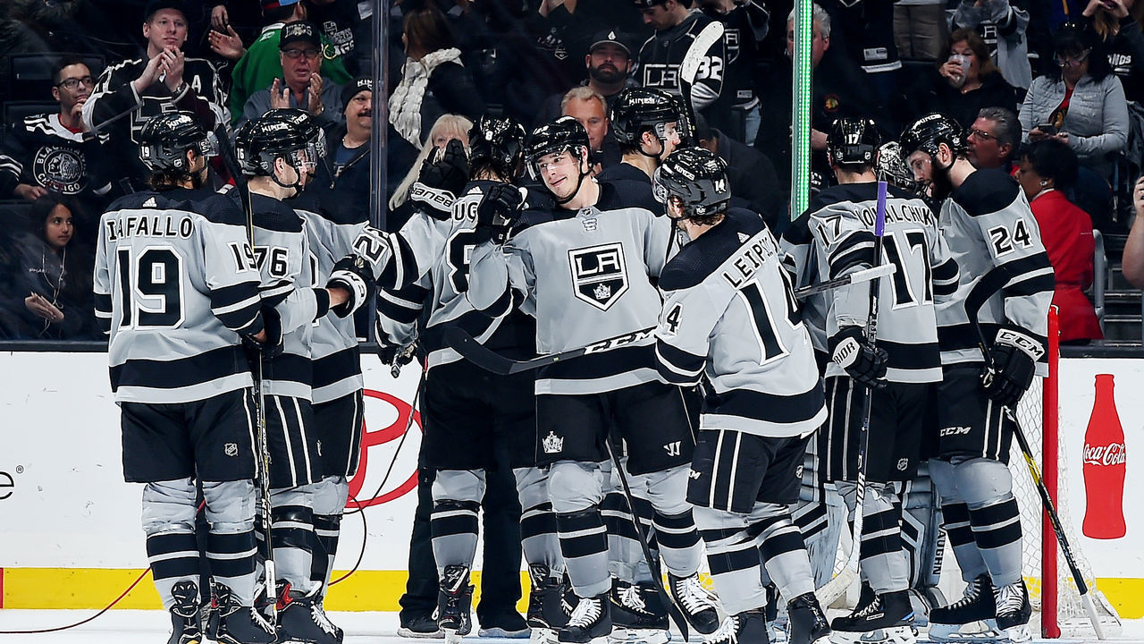 LOS ANGELES, CA - MARCH 2: Dustin Brown #23 of the Los Angeles Kings, center, celebrates with his team after defeating the Chicago Blackhawks 6-3 in the game at STAPLES Center on March 2, 2019 in Los Angeles, California. It was Brown's 1,100th NHL career game.