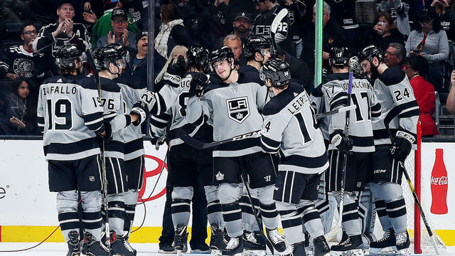 LOS ANGELES, CA - MARCH 2: Dustin Brown #23 of the Los Angeles Kings, center, celebrates with his team after defeating the Chicago Blackhawks 6-3 in the game at STAPLES Center on March 2, 2019 in Los Angeles, California. It was Brown's 1,100th NHL career game.