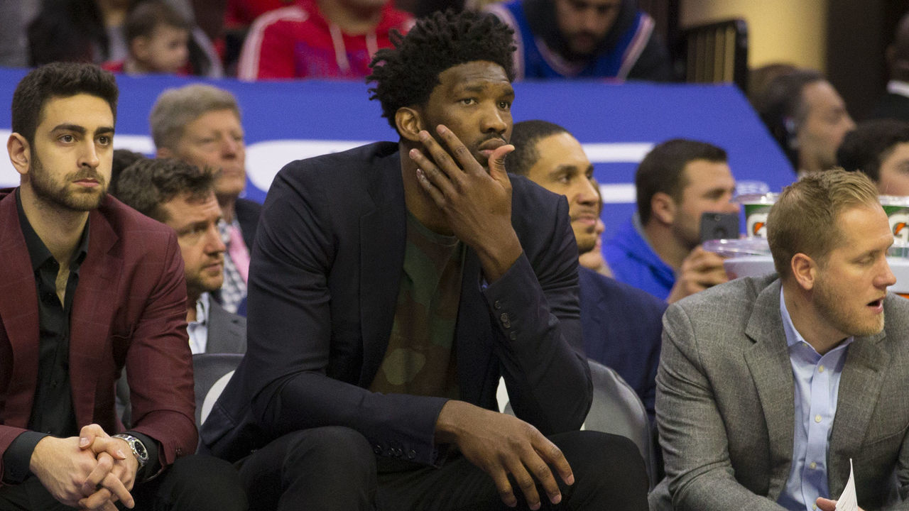 PHILADELPHIA, PA - FEBRUARY 23: Jonah Bolden #43, Furkan Korkmaz #30, and Joel Embiid #21 of the Philadelphia 76ers watch the game from the bench against the Portland Trail Blazers in the third quarter at the Wells Fargo Center on February 23, 2019 in Philadelphia, Pennsylvania. The Trail Blazers defeated the 76ers 130-115.