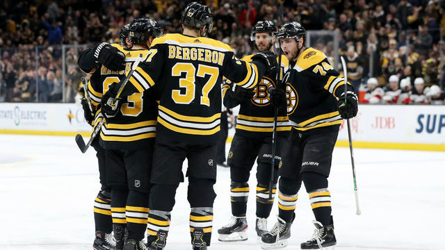 BOSTON, MASSACHUSETTS - MARCH 02: Brad Marchand #63 of the Boston Bruins celebrates with Patrice Bergeron #37 and Jake DeBrusk #74 after scoring a goal against the New Jersey Devils during the first period at TD Garden on March 02, 2019 in Boston, Massachusetts.