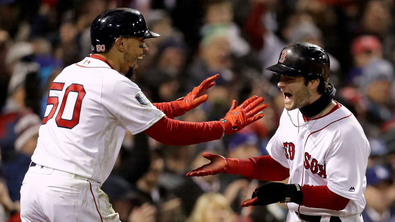 BOSTON, MA - OCTOBER 24: Mookie Betts #50 and Andrew Benintendi #16 of the Boston Red Sox celebrate each scoring a run on a hit by teammate J.D. Martinez (not pictured) during the fifth inning against the Los Angeles Dodgers in Game Two of the 2018 World Series at Fenway Park on October 24, 2018 in Boston, Massachusetts.