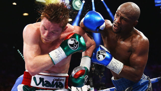 LAS VEGAS, NV - SEPTEMBER 14: (L-R) Floyd Mayweather Jr. throws a right to Canelo Alvarez during their WBC/WBA 154-pound title fight at the MGM Grand Garden Arena on September 14, 2013 in Las Vegas, Nevada.