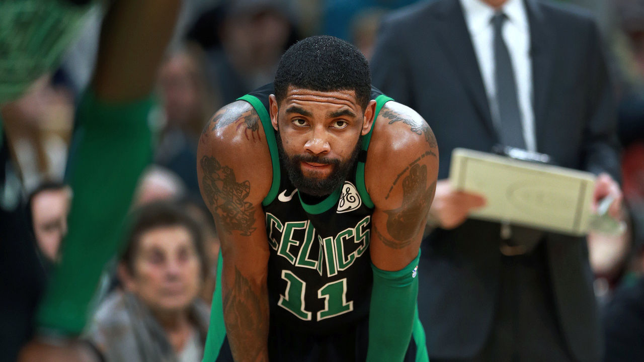 BOSTON - MARCH 3: Boston Celtics' Kyrie Irving (11), head coach Brad Stevens (background right) and Jaylen Brown (foreground left) look on with a minute left in the game and the Rockets at the free throw line. The Boston Celtics host the Houston Rockets in a regular season NBA basketball game at TD Garden in Boston on March 3, 2019.