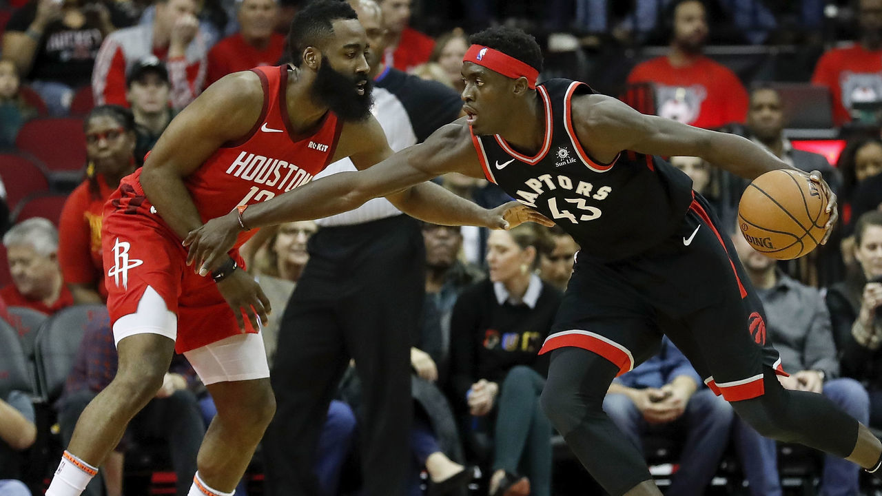HOUSTON, TX - JANUARY 25: Pascal Siakam #43 of the Toronto Raptors dribbles the ball defended by James Harden #13 of the Houston Rockets in the first half at Toyota Center on January 25, 2019 in Houston, Texas.
